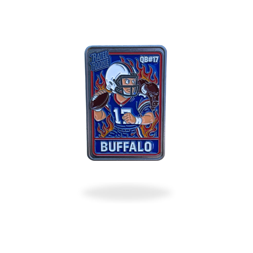Illustrated enamel ball marker styled like a vintage football rookie trading card, featuring a cartoon quarterback in a red and blue Buffalo uniform mid-throw, with flames in the background and bold “Rated Rookie” text. Designed for golf use with collectible appeal.