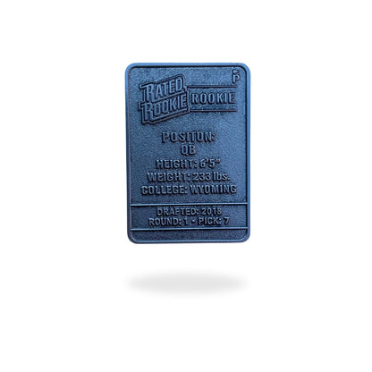Illustrated enamel ball marker styled like a vintage football rookie trading card, featuring a cartoon quarterback in a red and blue Buffalo uniform mid-throw, with flames in the background and bold “Rated Rookie” text. Designed for golf use with collectible appeal.