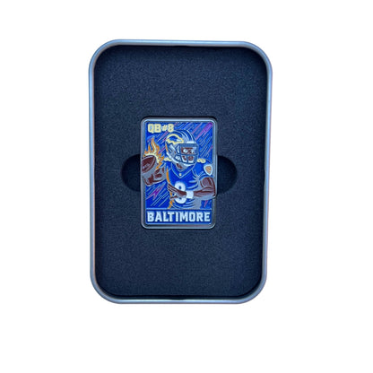 Enamel ball marker styled like a retro football trading card, featuring a cartoon quarterback in a purple and black Baltimore uniform with flames in the background. “Rated Rookie” text is displayed at the top, blending football iconography with collectible golf accessory design.