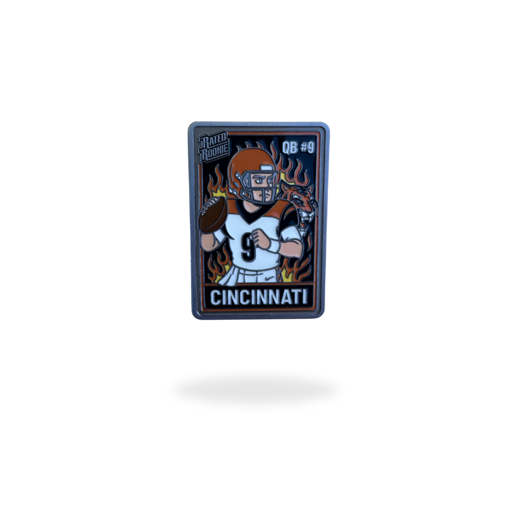 Cincinnati QB #9 ball marker featuring a cartoon football player with orange helmet and flames in the background – collectible enamel golf ball marker by Pin Creatures.